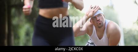 Tired sweaty middle aged man after running in early morning Stock Photo