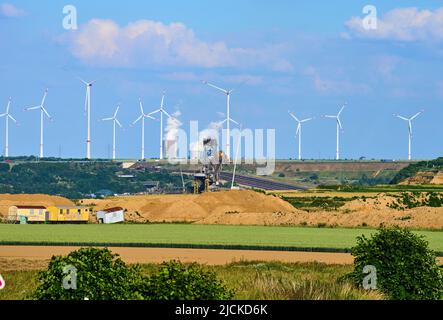 Wind turbines near the village of  Lützerath on Juni 13, 2022  in Lützerath, Germany.  Lützerath is a hamlet of the town of Erkelenz in North Rhine-Westphalia. The energy supply group RWE plans to demolish Lützerath completely in order to expand the Garzweiler opencast mine and open up the area for the mining of brown coal.  © Peter Schatz / Alamy Live News Stock Photo