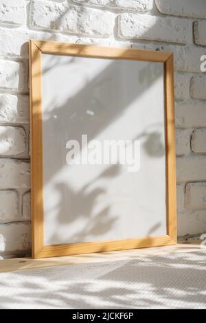 Photo frames on floor over white brick wall Stock Photo