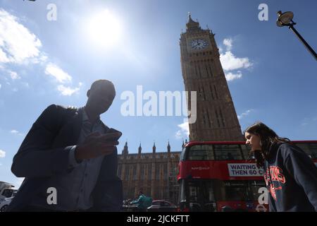 A man walks past Elizabeth Tower, central London, during the warm weather. Picture date: Tuesday June 14, 2022. Stock Photo