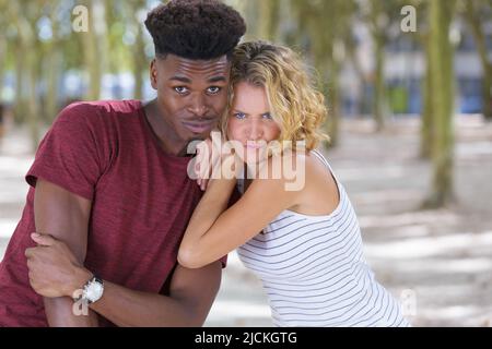 friends making faces outdoors Stock Photo