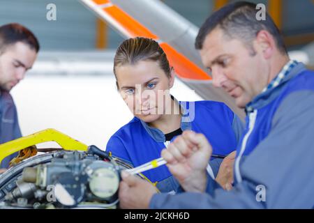 two mechanics working in car repair service Stock Photo