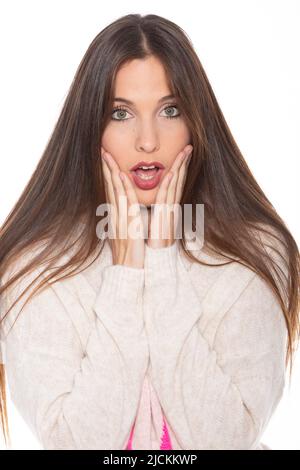 Portrait Of Surprised Young Woman Against white Background Stock Photo