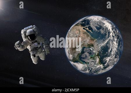 Spaceman in outer space with Earth planet. Elements of this image furnished by NASA. Stock Photo