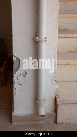 Peeling outdoor wall.  Vertical. The paint is peeling off. Paint chips from wall. Stock Photo