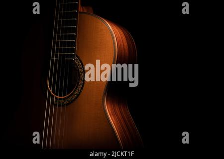 Classical guitar on a black background with negative space for copy Stock Photo