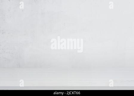 Clean white wooden desk with white wall in background for product presentation Stock Photo