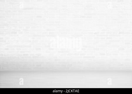 White brick wall and wooden floor. Empty room for copy or product presentation Stock Photo