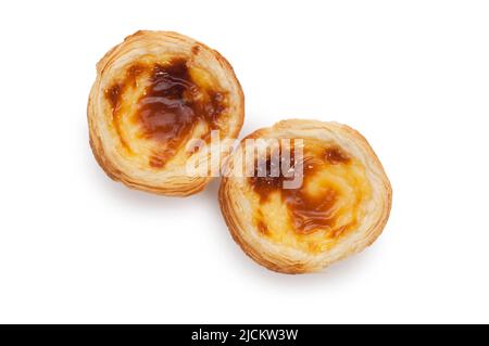Studio shot of individual custard tarts cut out against a white background - John Gollop Stock Photo