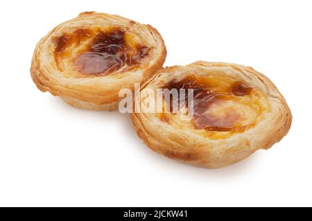 Studio shot of individual custard tarts cut out against a white background - John Gollop Stock Photo