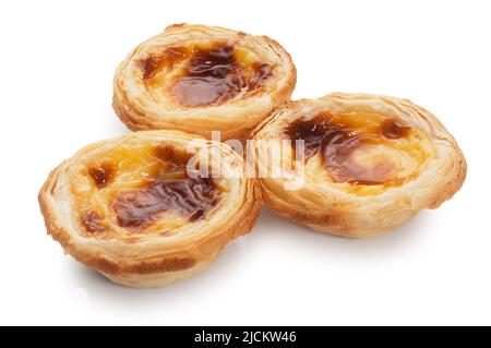 Studio shot of individual custard tarts cut out against a white background - John Gollop Stock Photo