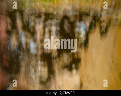 abstract design background backdrop of beige black and blue soft focus motion blur created by long time exposure and intentional camera movement Stock Photo