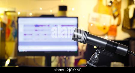 Podcasting concept, vintage recording microphone and messy workplace on blurred background Stock Photo