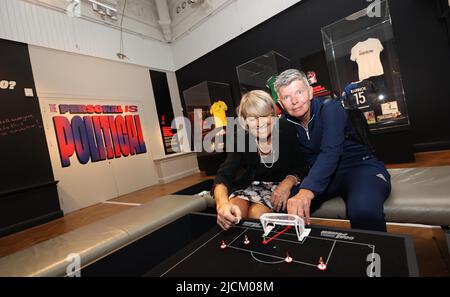 Brighton, UK. 14th June, 2022. Goal Power Women's Football 1894-2022 Exhibition launch outside the Royal Pavillion in Brighton. L-R Rose Reilly and Chris Lockwood have a game of subbuteo part of the exhibition. Credit: James Boardman/Alamy Live News Stock Photo