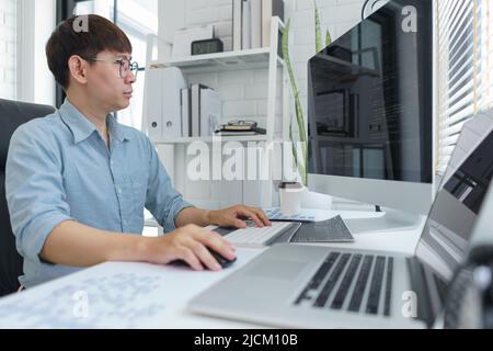 Software development concept, Male programmer typing data code on laptop to develop app and website. Stock Photo