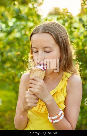 Happy girl with braces eating italian ice cream cone smiling while ...