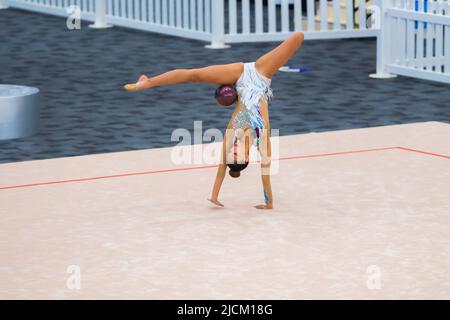 Australian Senior International Rhythmic Gymnast, Ashari Gill twisted with a hoop during 2022 Oceania Rhythmic Gymnastics Continental Championships. The event was running in parallel with Australian Gymnastics Championships on Gold Coast, Queensland. Stock Photo