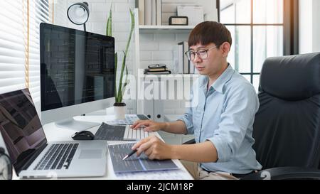 Software development concept, Male programmer pointing on data code to checking website programming. Stock Photo