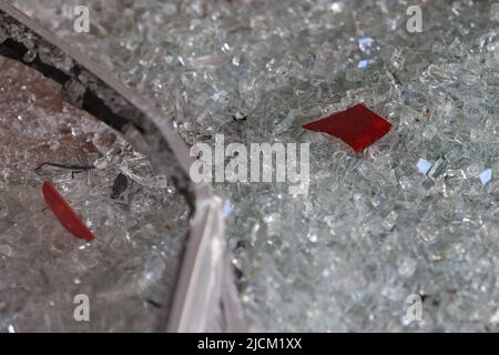 Duesseldorf, Germany. 14th June, 2022. Broken taillights lie among broken glass inside the store. Unknown persons stole several luxury watches from a store on Düsseldorf's Königsallee on Tuesday night. According to police, they drove a stolen car several times backwards against the door of a side entrance and into a shop window. This broke the window, allowing them to enter the watch store. They took several watches from a display case and fled by car. Credit: David Young/dpa/Alamy Live News Stock Photo