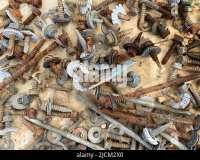 many old rusty screw heads, bolts, metal nuts Stock Photo