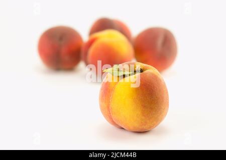 Fresh peaches on bright background. Selective focus. Stock Photo