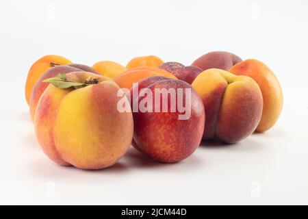 Peaches, nectarines and apricots on bright background. Close up view. Stock Photo