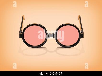 From above of stylish round black sunglasses placed on orange background in studio Stock Photo