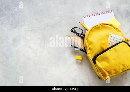 School bag with with colorful school items, top view Stock Photo