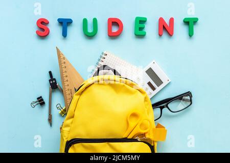 Students supplies in yellow school backpack. Back to school concept Stock Photo