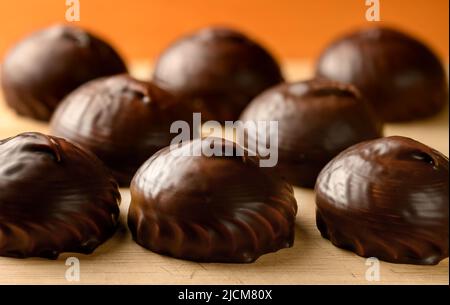 Chocolate covered marshmallows on the table front view Stock Photo