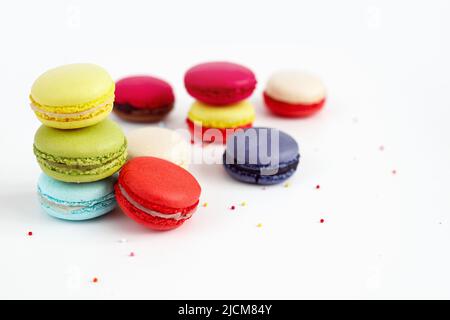 Stack of colourful macaroons or macaron isolated on white, French dessert background. Stock Photo