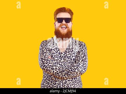 Portrait of strange funny cool chubby bearded man isolated on orange background. Stock Photo