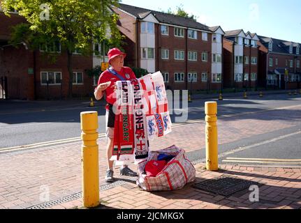 A street vendor sells merchandise ahead of the UEFA Nations League match at the Molineux Stadium, Wolverhampton. Picture date: Tuesday June 14, 2022. Stock Photo