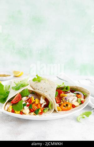 Mexican tacos with chicken meat and vegetables Stock Photo