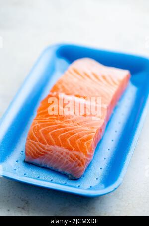 Fresh raw salmon in plastic container, close up view. Stock Photo