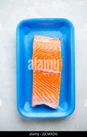 Fresh raw salmon in plastic container, close up view. Stock Photo
