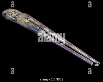 Old rusty adjustable wrench isolated on black background Stock Photo