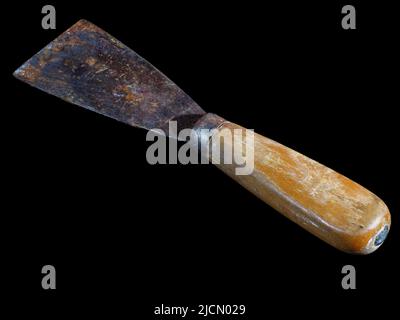 Old used rusty hand scraper isolated on black background Stock Photo