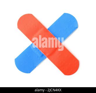 Crossed colorful red and blue adhesive bandage patches isolated on white Stock Photo