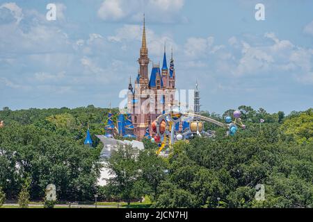 Cinderella Castle at Disney World appearing out from the trees Stock Photo