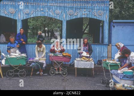 Women using converted baby carriages selling food to passenegers on Trans Siberian railroad. When train makes a stop here, passengers often buy food from these vendors to eat when coninuing their trip on the train.. Stock Photo