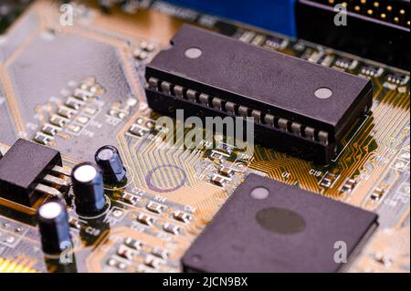 macro close-up shot of microchip on printed circuit board, computer motherboard with components Stock Photo