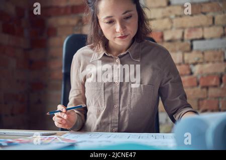 Portrait ob busy woman, interior designer working in her office Stock Photo