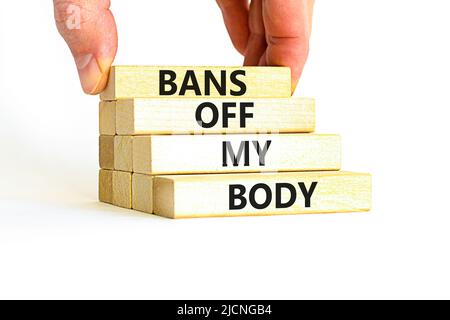 Bans off my body symbol. Concept words Bans off my body on wooden blocks on a beautiful white table white background. Women rights concept. Business s Stock Photo