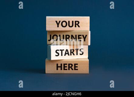 Your journey starts here symbol. Concept words Your journey starts here on wooden blocks on a beautiful grey table grey background. Business, motivati Stock Photo