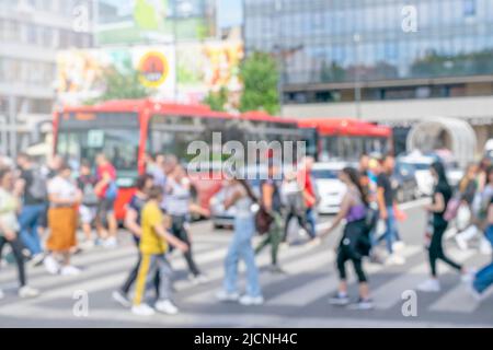 Busy commuters crossing street in downtown district during office rush hours Stock Photo