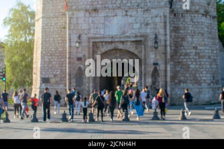 Blurred motion of crowd pedestrians crossing street in pedestrian walkway against urban buildings with city scene Stock Photo