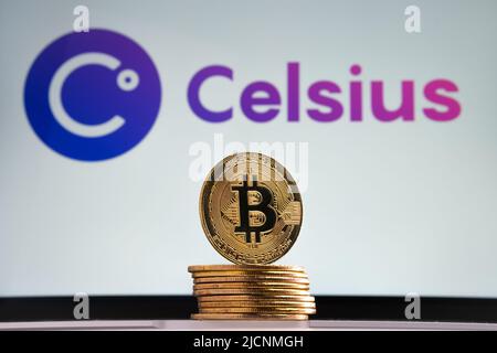 Bitcoin tokens seen in front and blurred Celsius crypto company logo on the blurred background. Stafford, United Kingdom, July 14, 2022 Stock Photo