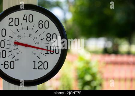 Outdoor thermometer in the shade during heatwave. Hot weather, high temperature and heat warning concept. Stock Photo