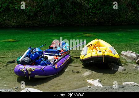 White water rafting trip on the Upper Grey river, south island, Aotearoa / New Zealand. Rafts tied up at the end of the day. Stock Photo